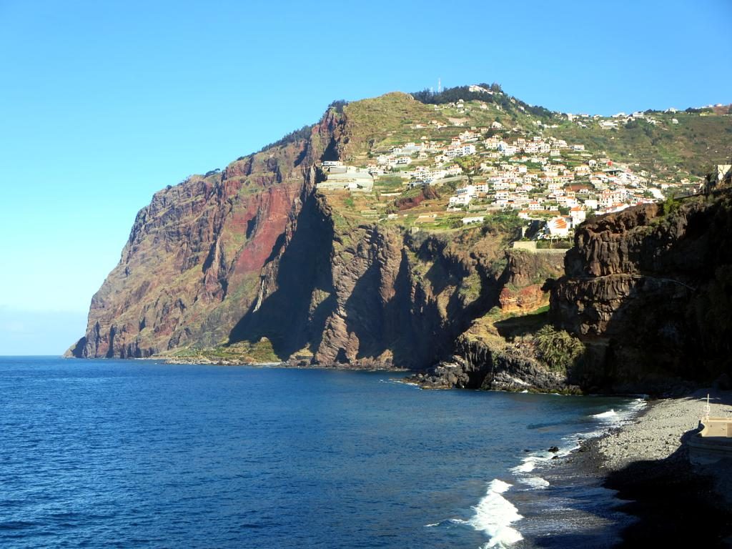 The high sea cliff at Cabo Girao on Madeira with terraced houses on the slope above it