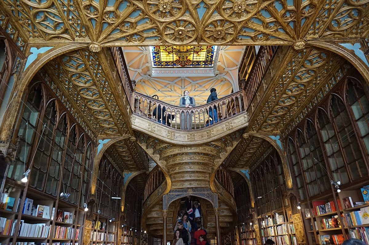 The crimson forked staircase and stained-glass skylight inside the Livraria Lello bookshop in Porto