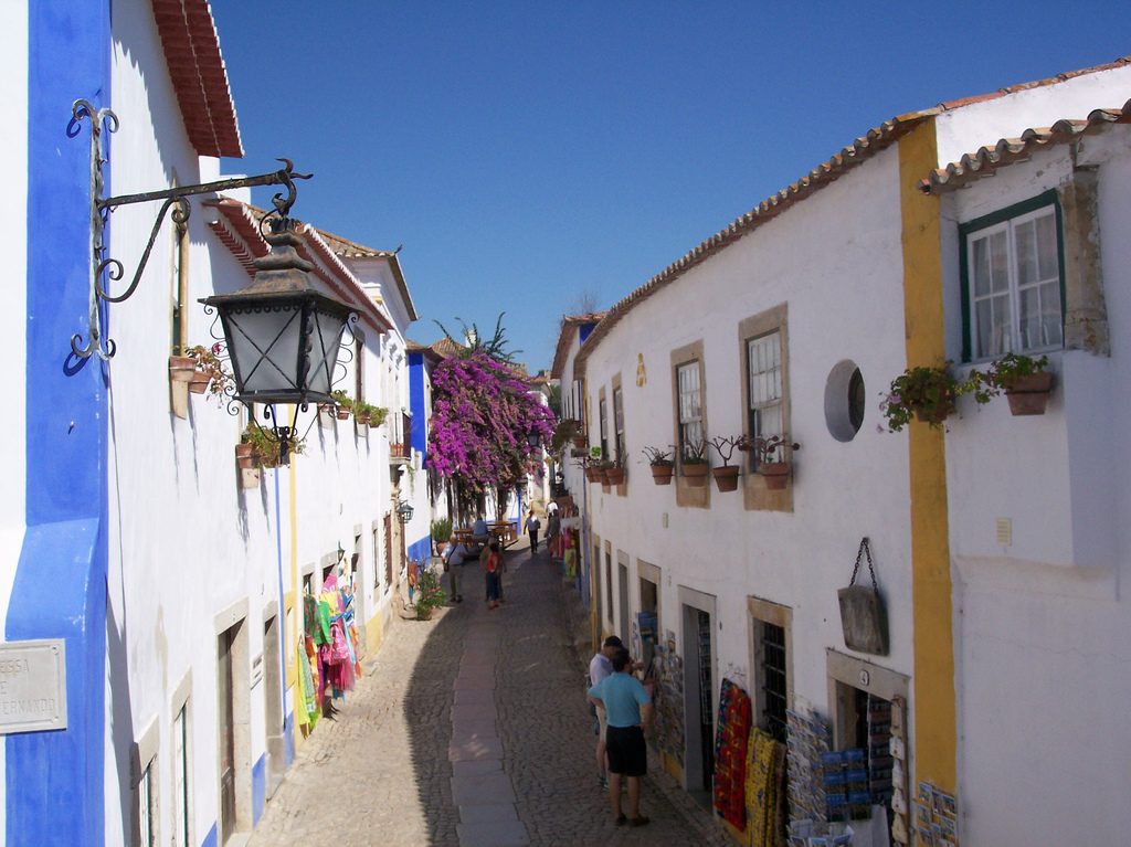 The main street inside the walls at Obidos, lined with whitewashed houses and bougainvillea
