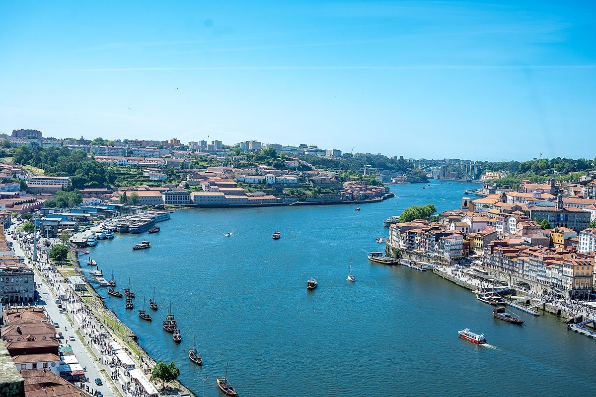 Porto's Ribeira waterfront and the Douro seen from the Dom Luís I bridge, with rabelo boats moored below