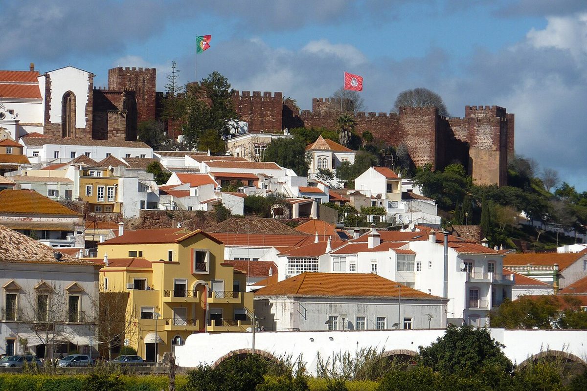 The red sandstone Moorish castle standing above the whitewashed town of Silves