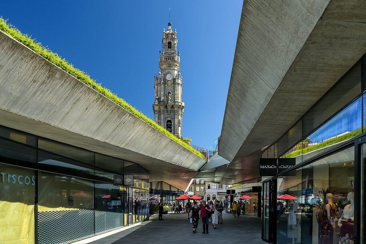 The baroque bell tower of the Clérigos rising above a modern shopping passage in central Porto